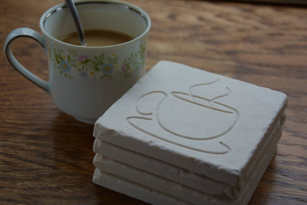 engraved marble coasters with coffee cup and saucer design